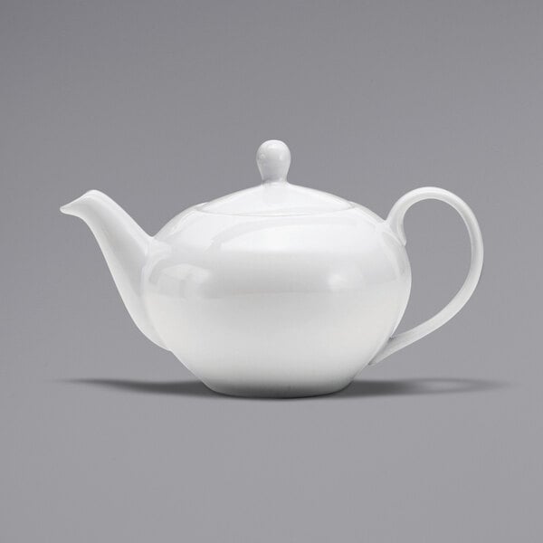 A white porcelain teapot with a handle.