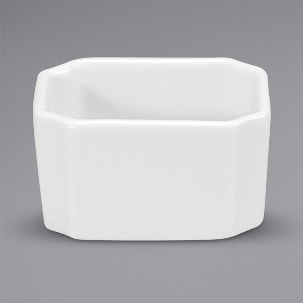 A white square porcelain sugar packet holder.