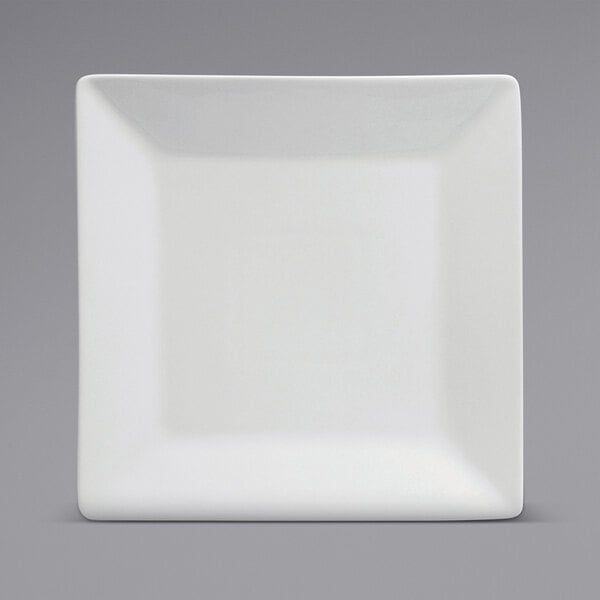 A close-up of a white Oneida Buffalo porcelain square plate with rolled edges.