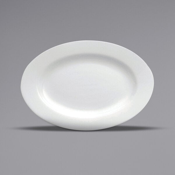 A close-up of a Oneida Buffalo Bright White Ware oval porcelain platter with a rolled edge on a gray surface.