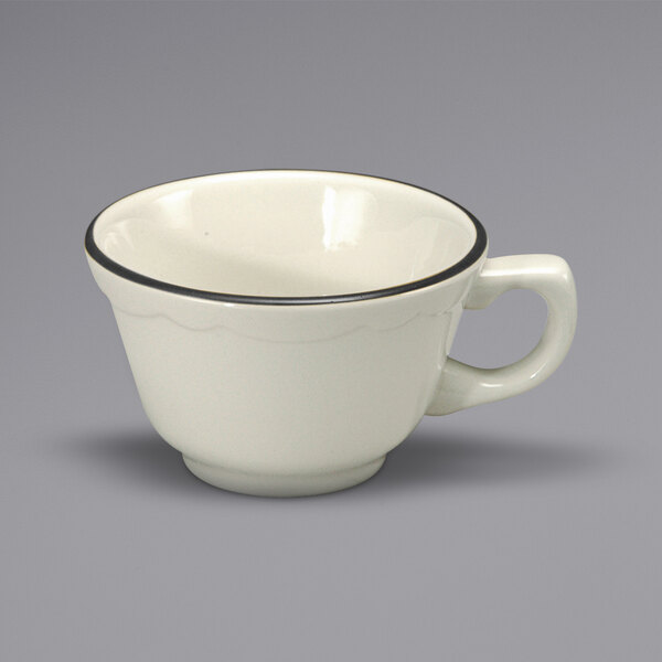 A white Oneida Buffalo Caprice china cup with a scalloped edge and a black rim.