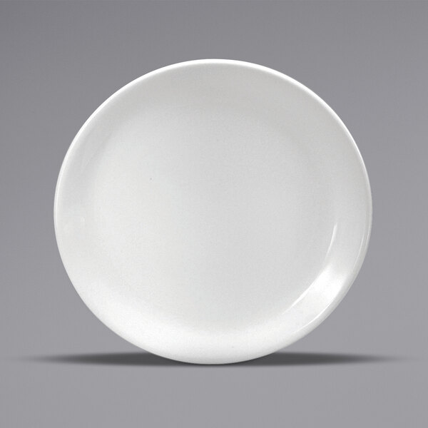 A close-up of a Oneida Buffalo Bright White Ware porcelain coupe plate with a rim.