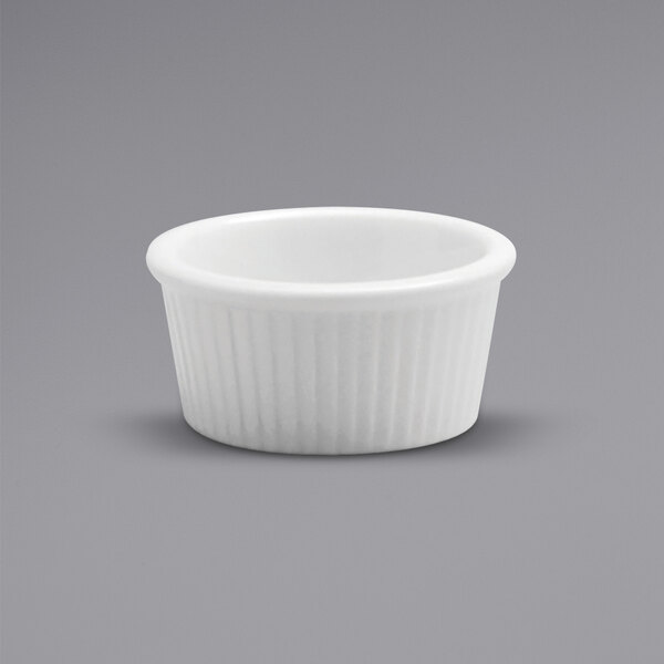 A white fluted porcelain ramekin.