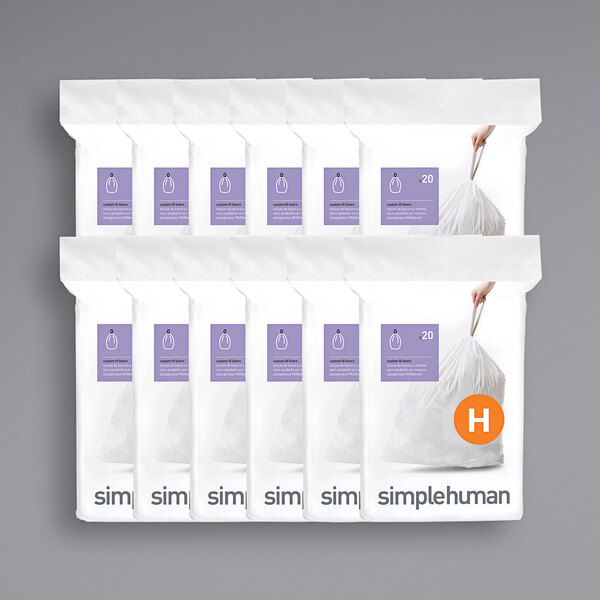 A group of simplehuman white custom fit trash can liners in white packaging.
