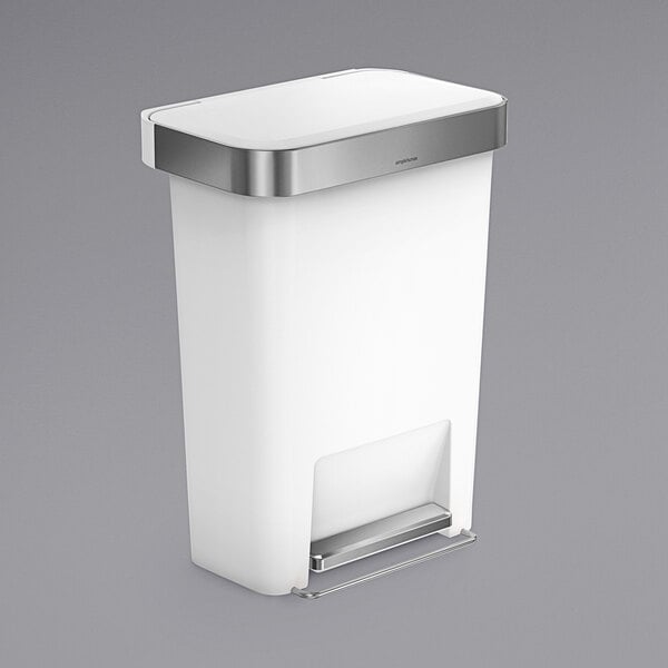 A white simplehuman rectangular front step-on trash can with a silver lid.