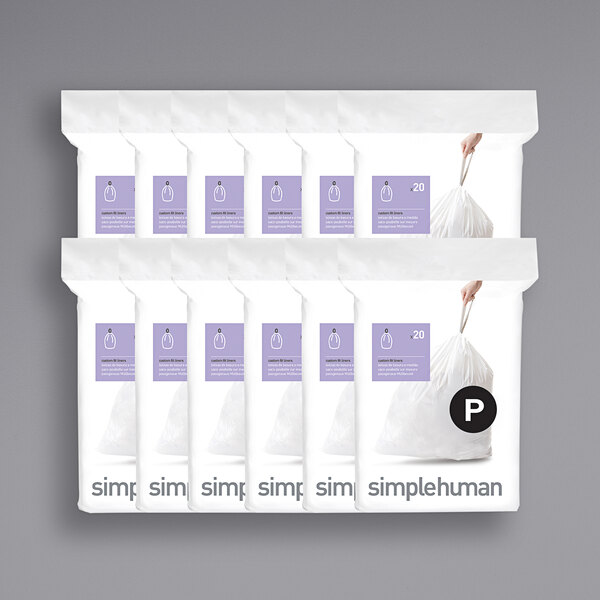 A hand holding a white simplehuman custom fit trash can liner package with a purple border.