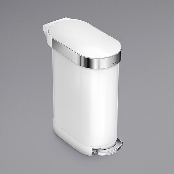 A white stainless steel simplehuman rectangular step-on trash can with a silver lid.