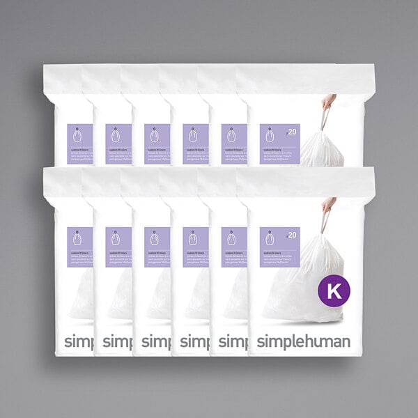 A group of six white packages of simplehuman trash can liners.