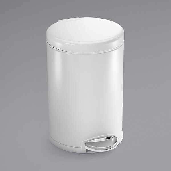 A white simplehuman stainless steel round step-on trash can with a lid.