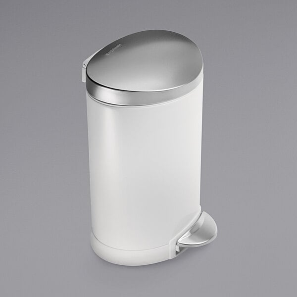 A white simplehuman semi-round step-on trash can with a silver lid.