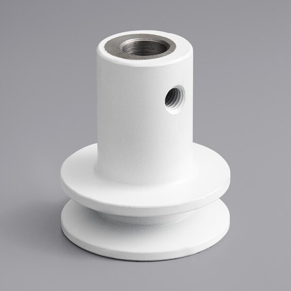 A white plastic pulley shaft with a hole in the center.