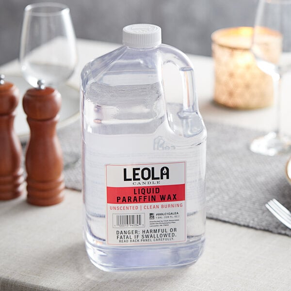 A close-up of Leola Candle 1 gallon jug on a table.