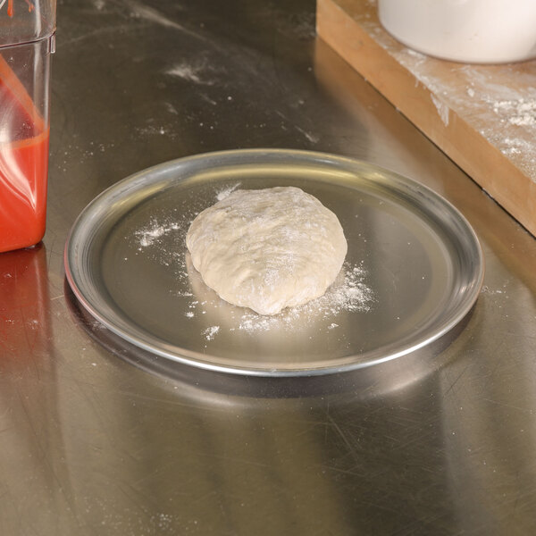 A ball of dough on an American Metalcraft aluminum pizza pan.