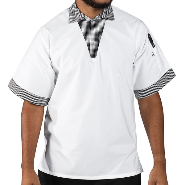 A man wearing a white Uncommon Chef v-neck pullover cook shirt with checkered trim.