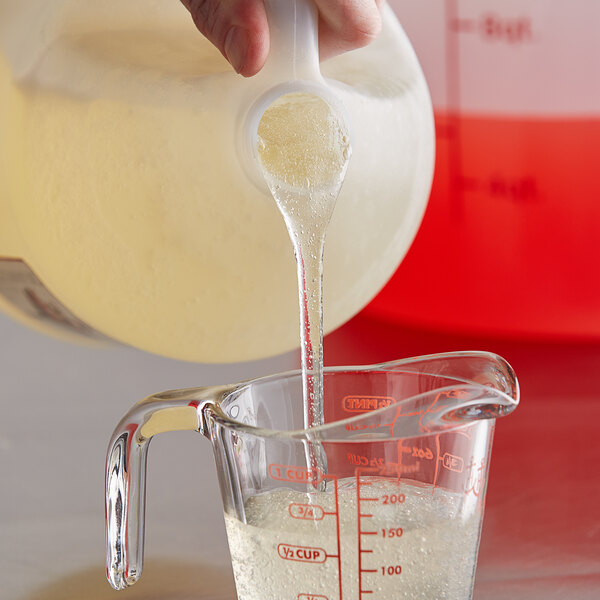 A person pouring I. Rice Neutral Sorbet Base into a measuring cup.