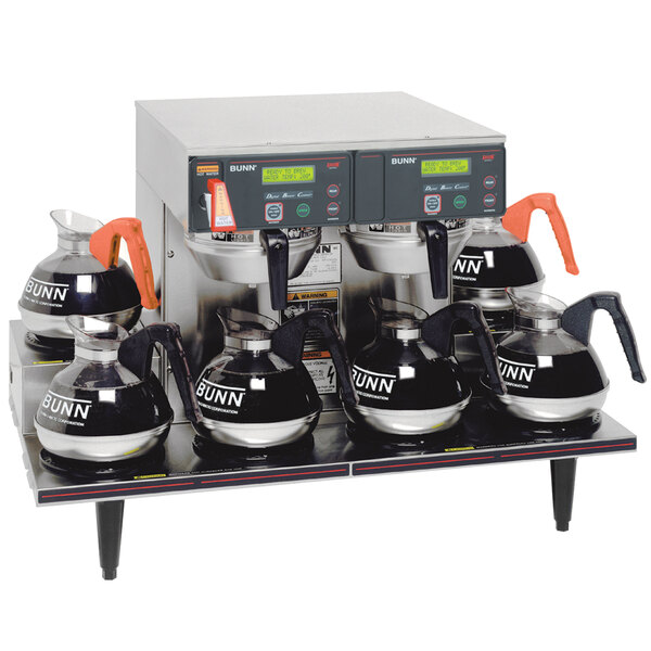 A Bunn Axiom 0/6 Twin Automatic Coffee Brewer with six coffee pots on top.