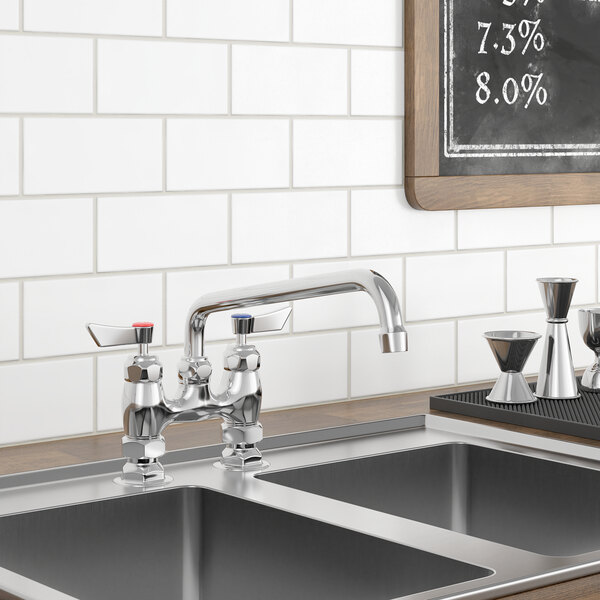 A Waterloo deck-mounted faucet on a kitchen counter above a sink with a chalk board on the wall.