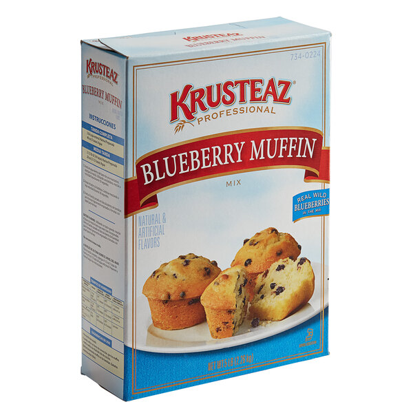 A case of 6 boxes of Krusteaz Professional blueberry muffin mix with a close up of a blueberry muffin on the box.