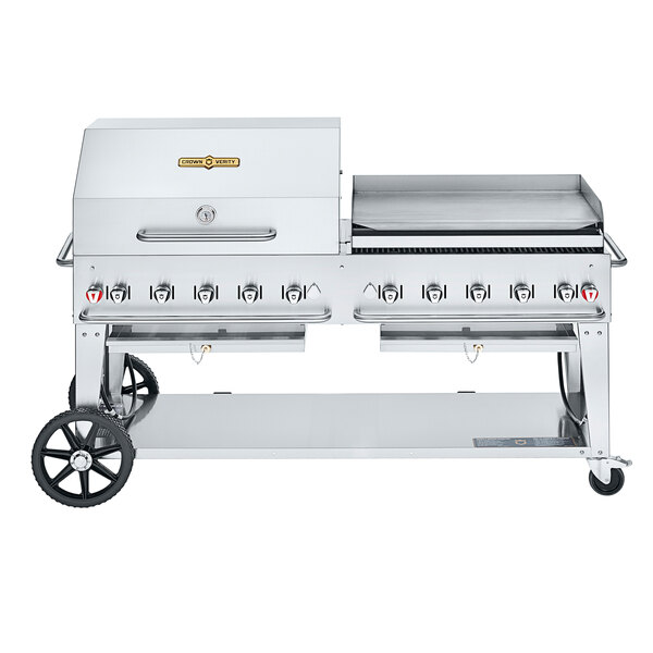 A large stainless steel Crown Verity outdoor grill with a dome and griddle attachment.