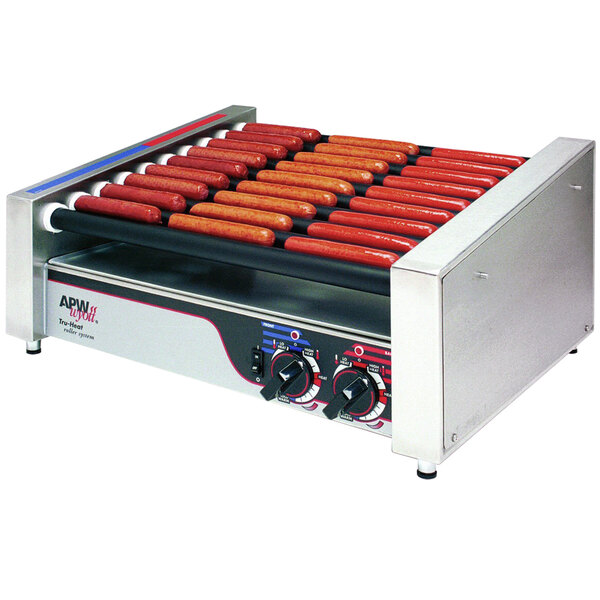 An APW Wyott hot dog grill with hot dogs cooking on it.