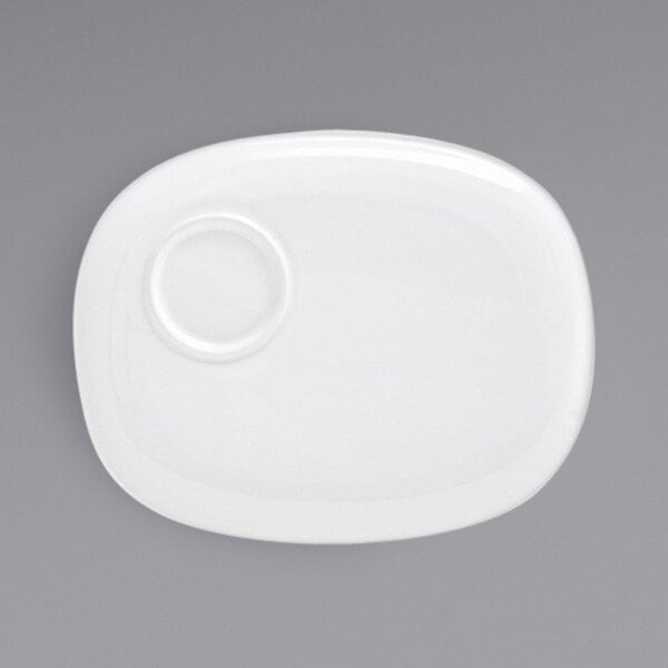 A white Front of the House porcelain plate with a small circle on it.