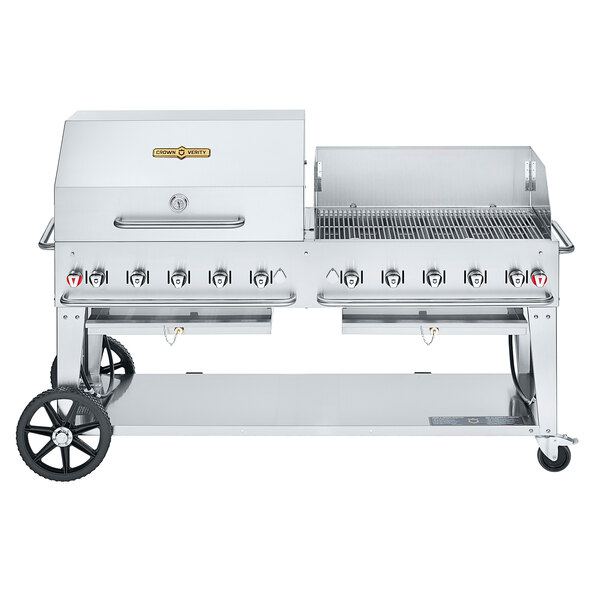 A large stainless steel Crown Verity mobile outdoor grill with a lid and roll dome/wind guard package.