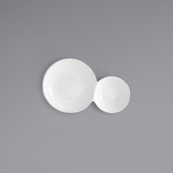 Two white Front of the House Harmony porcelain plates with curved and two-part designs.