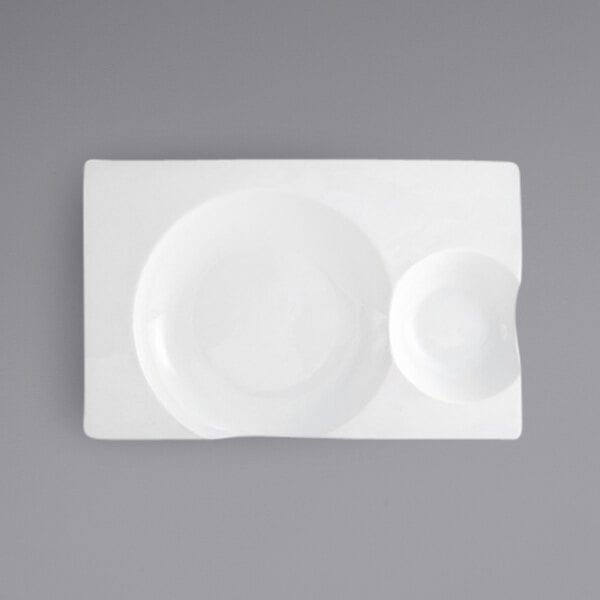 A close up of a Front of the House Harmony rectangular white porcelain plate with two compartments.