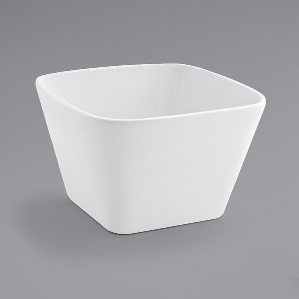 A case of 12 white square Front of the House porcelain bowls on a gray background.