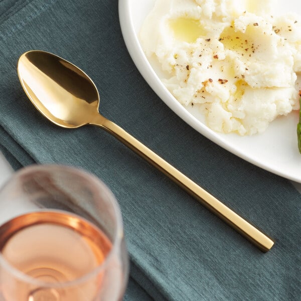 A plate of mashed potatoes and an Acopa Phoenix stainless steel dinner spoon.