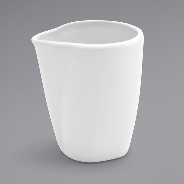 A Front of the House bright white porcelain creamer with a small handle.