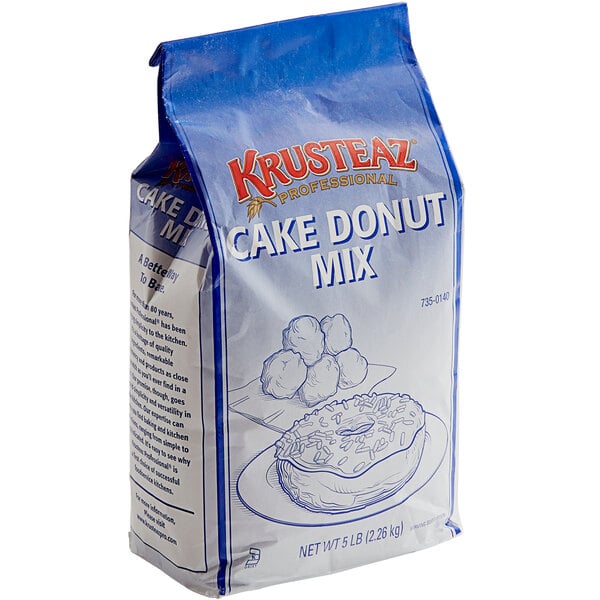 A white and blue bag of Krusteaz Professional Donut Mix with a drawing of donuts and balls.