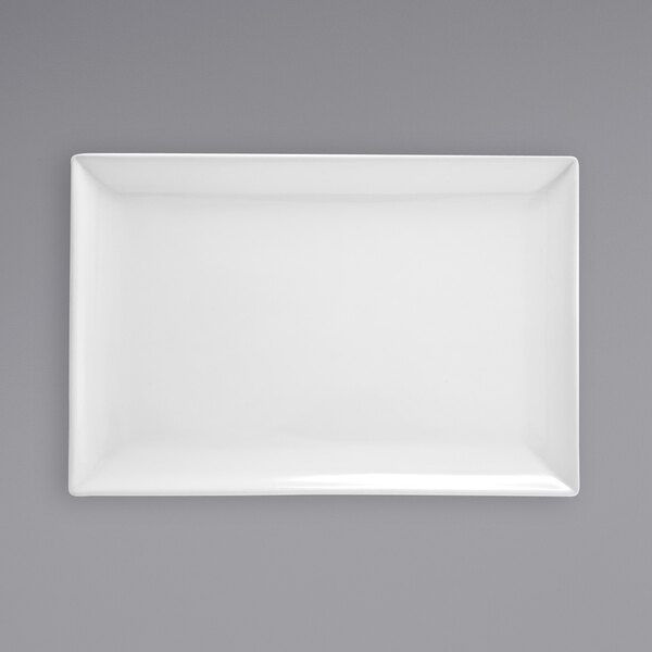 A white rectangular Front of the House porcelain plate on a gray surface.