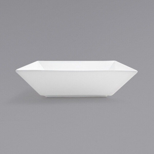 A Front of the House Kyoto bright white square porcelain bowl on a gray surface.