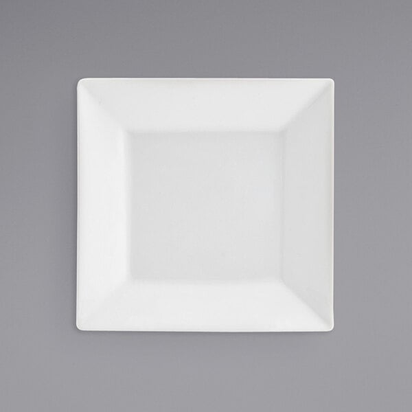 A close-up of a Front of the House Kyoto bright white square porcelain plate.
