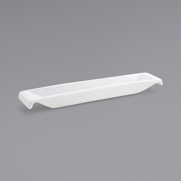 A white rectangular porcelain ramekin with a handle.