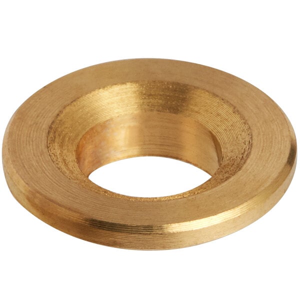 A close-up of a brass spring gasket with a gold circle.