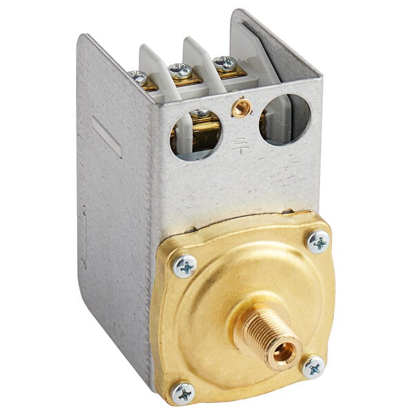 A metal box with a gold and white metal pressure switch inside.