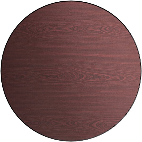 A Lancaster Table & Seating round laminated table top with a cherry wood surface and black border.