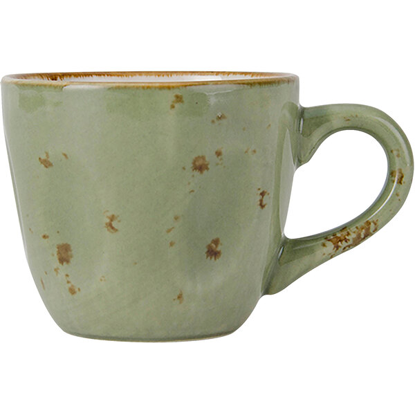 A green Tuxton china cup with brown specks and a handle.