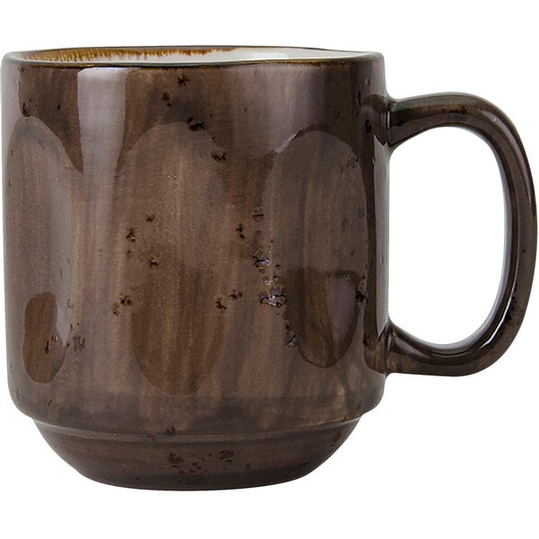A close-up of a brown Tuxton mug with a handle.