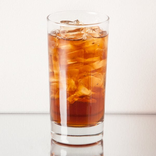 A Libbey customizable beverage glass filled with iced tea on a white background.
