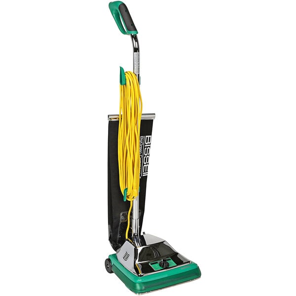 A Bissell Commercial ProShake bagged upright vacuum cleaner with a green and black handle.