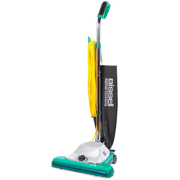 A green and yellow Bissell Commercial ProBag upright vacuum cleaner with a handle.