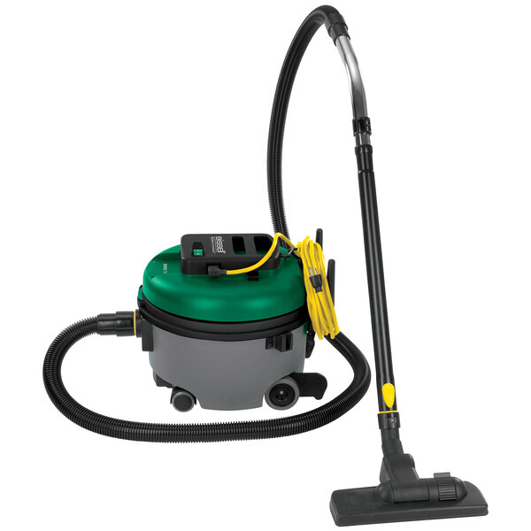 A green and black Bissell Commercial canister vacuum cleaner with wheels and an extension hose.