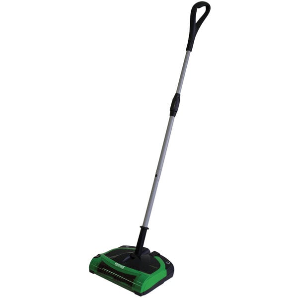 A green and black Bissell Commercial cordless floor sweeper with a handle.