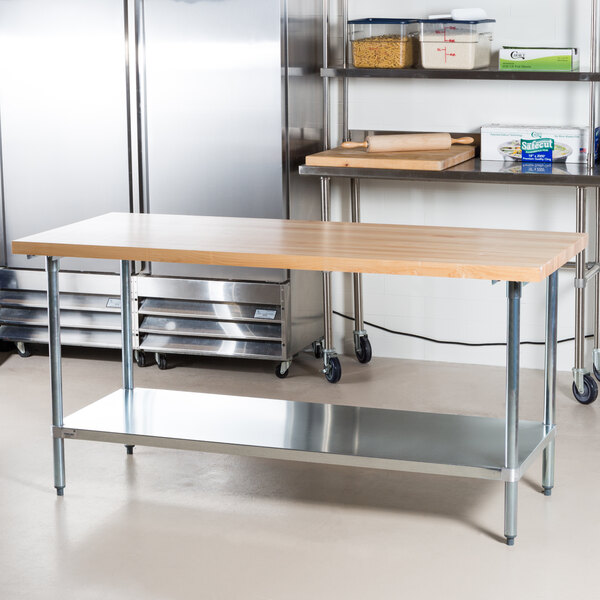 An Advance Tabco wood top work table with a galvanized base and metal undershelf.