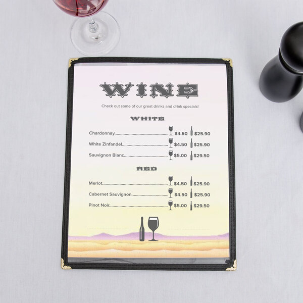 A 8 1/2" x 11" menu with a Southwest themed cactus design on a table with a glass of wine.