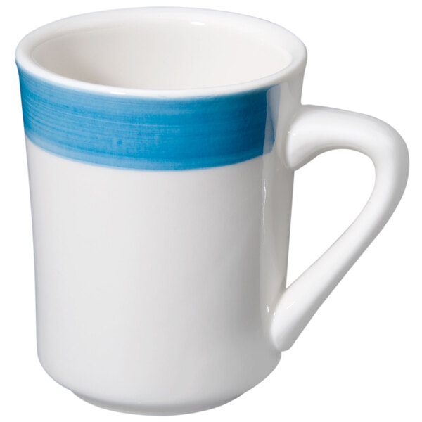 A close-up of a white and blue CAC Tierra coffee mug with a white handle.