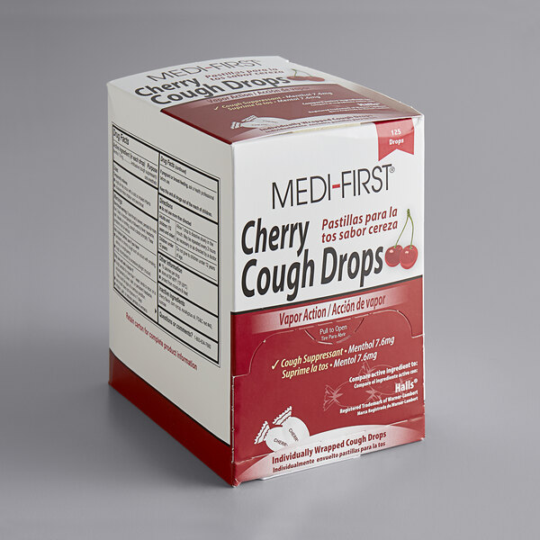 A box of Medique Medi-First cherry cough drops on a table.